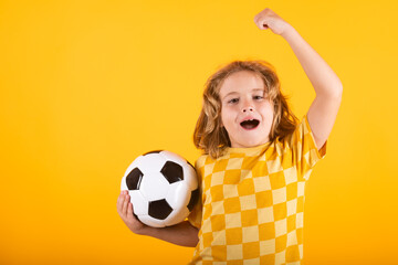 Kid holding soccer ball and smiling at camera, playing football, studio. Sport and leisure, soccer hobby for kids. Little boy holding soccer ball. Fan sport boy soccer player with football ball.