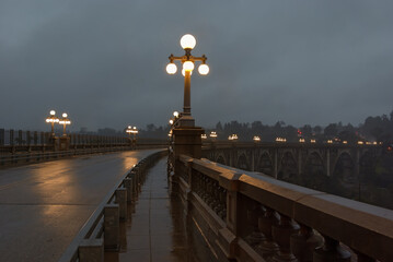 The Colorado Street Bridge in Pasadena, California shown on a rainy evening.