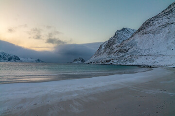 Fototapeta na wymiar norway lofoten islands winter season snow covered landscapes beaches cloudy sky and colorful houses