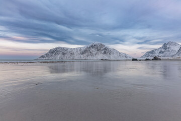 norway lofoten islands winter season snow covered landscapes beaches cloudy sky and colorful houses