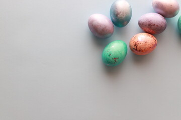 Flat lay multi-colored eggs in the corner, top view