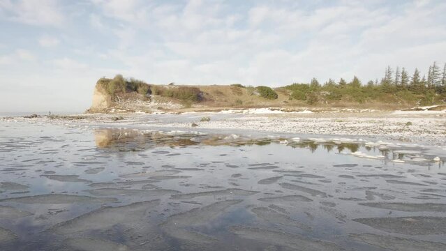 Frozen Limfjord Laguna and Fur Island Cliff under the Snow With Amazing Reflection in the Water - Aerial Drone Shot