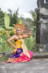 A serene Bali moment of cultural expression amidst a lush green backdrop.