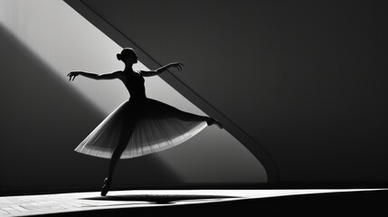  a black and white photo of a woman in a tutu and a long skirt, with her arms stretched out, in front of a wall with a shadow.