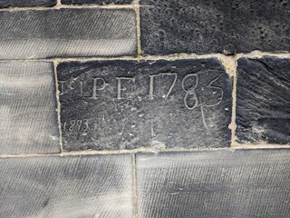Example of historical graffiti from 1783 scratched into church brickwork