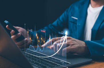 Businessman analyzes financial data, including forex trading graphs, business finance, technology,...