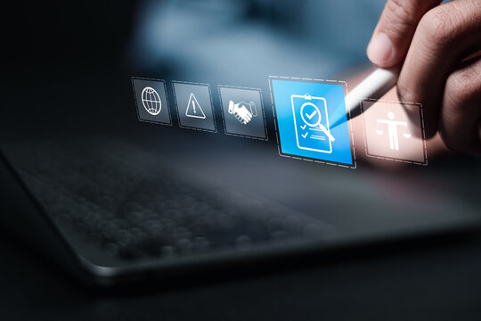 Compliance in business concept. Person use laptop with compliance icon on virtual screen, ensuring the enforcement of laws, regulations, and standards. Stay in line with business policies.