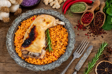 Grilled chicken leg with bulgur wheat in the copper bowl. 