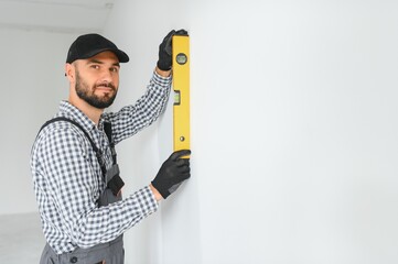 Young worker making repair in room.