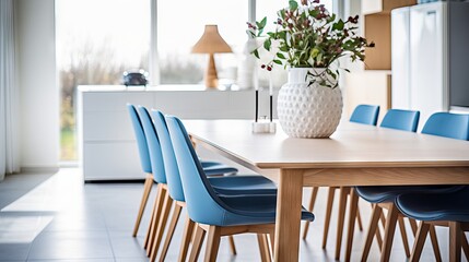 Modern Scandinavian dining room with wooden table and blue chairs