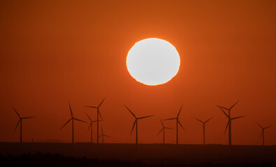 The sun sets over a wind farm in the Almaty region of Kazakhstan.