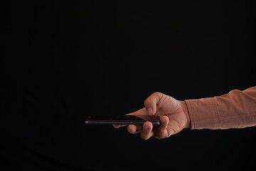 Close-up of a man's hand using a cell phone