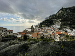 Fototapeta premium Amalfi, Amalfi coast, Salerno, Italy. glimpses of Amalfi, the town between lemon groves and the Lattari mountains, view of the Amalfi cathedral with its bell tower with the sea