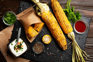 Grilled corn on the cob on kitchen table flat lay healthy food background