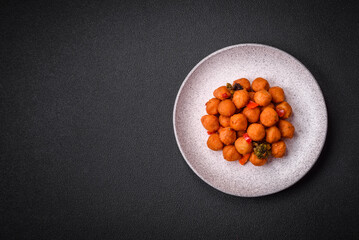 Delicious fried potato balls with vegetables, salt, spices and herbs