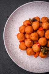 Delicious fried potato balls with vegetables, salt, spices and herbs