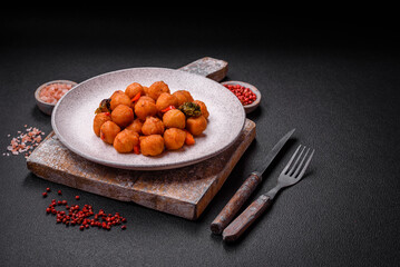 Delicious fried potato balls with vegetables, salt, spices and herbs