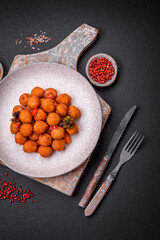 Delicious fried potato balls with vegetables, salt, spices and herbs