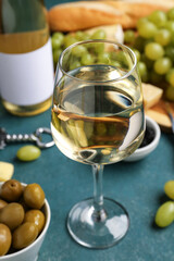 Glass of exquisite wine on green background
