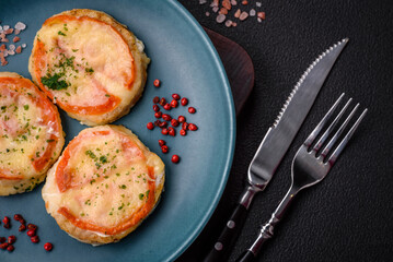 Delicious baked fish fillet with cheese, tomatoes, salt, spices and herbs