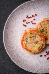 Delicious baked fish fillet with cheese, tomatoes, salt, spices and herbs