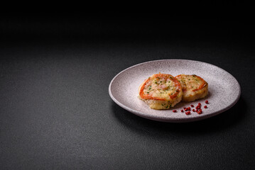 Delicious baked fish fillet with cheese, tomatoes, salt, spices and herbs