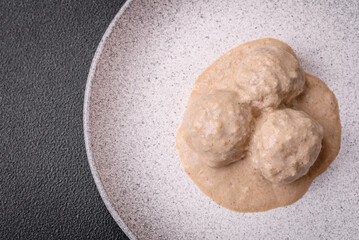 Delicious meatballs from minced chicken or turkey with sour cream sauce