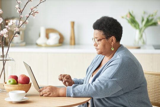 Senior Black Woman Using Internet On Laptop