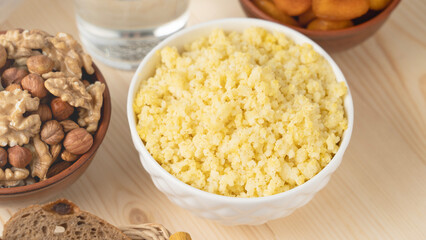 A dish of healthy cereals - millet porridge in a clay bowl. Selective focus, millet porridge in a cup