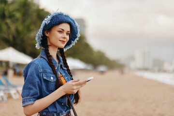 Pretty Young Lady Outdoors, Holding Smartphone, Using Messaging App on a Summer Vacation in the City