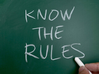 Know the rules, word text written on chalkboard, motivational inspirational quote