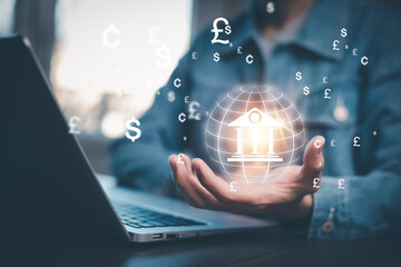Businessman  holding virtual bank with currency sign for forex exchange and global money transfer by technology concept.