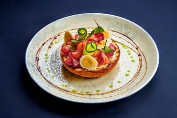 Toast with salmon and vegetables in a plate