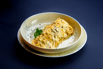 Carbonara pasta with cream and cheese in a plate