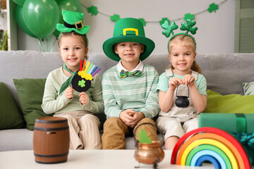 Cute kids celebrating St. Patrick's Day with festive green outfits at home party