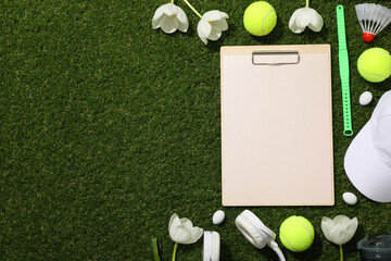 Notepad with sports accessories and spring flowers.