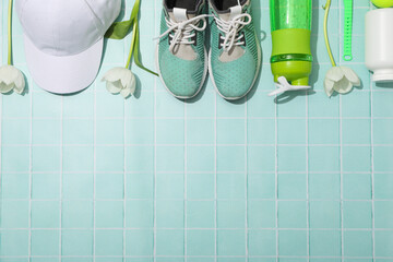 Sportswear and accessories, with flowers, on a blue background.