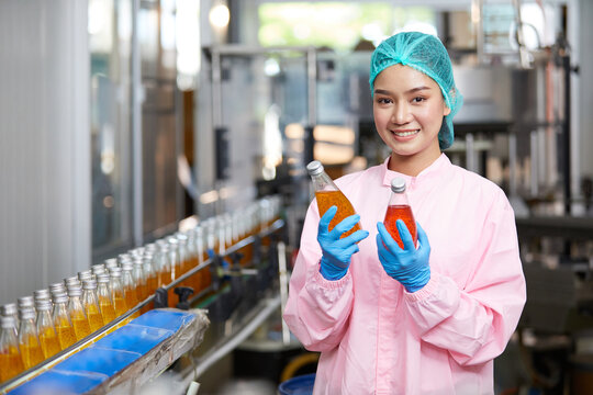 factory worker holding and checking basil seed drinks in the beverage factory