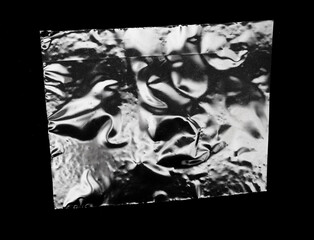 A Piece Of Square Plastic On A Black Background