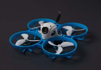 Small blue reconnaissance drone isolated on a gray background. Close-up technique.