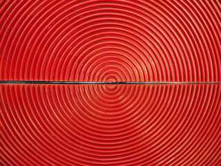 The geometric shape produced by a concentrated arrangement of red semi-circular planes reflected onto a mirror, resembling a red concentric circle pattern. Ideal for concentric circle backgrounds.