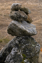 Fototapeta na wymiar stones stacked on top of each other in a meadow