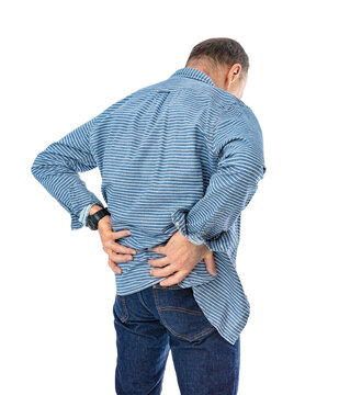 Back side portrait of sixty year old man holds his arms around his lower back and bent over in pain, isolated on white background. Man in striped shirt and blue jeans posing in studio.
