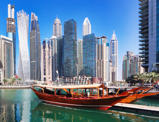 Fototapeta na wymiar Dubai marina promenade in UAE. Highrise residential buildings, business skyscrapers