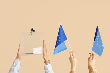 Hands with ballot box and EU flags on beige background. Election concept