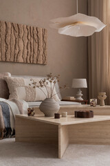 Modern composition of japandi interior with design beige sofa, natural colors paintings, stone...