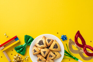 Top view shot of Purim festivity essentials, including filled-pocket cookies on plate, ribbon...