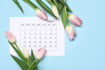 Calendar and tulips on light blue background. International Women's Day celebration