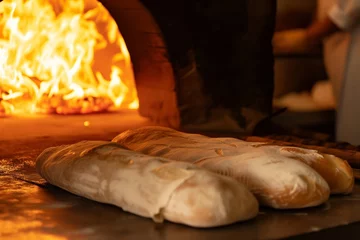 Foto op Canvas chef bakes bread in a woodfired oven © primopiano