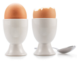 Brown soft-boiled chicken eggs in the egg cups isolated on white background.